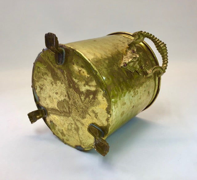Bronze or brass container with decorative elements on a white background