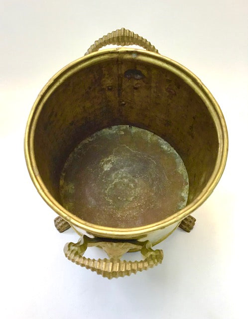 Bronze or brass decorative container with intricate designs on a white background