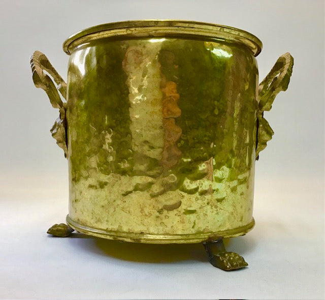 Gold-colored metal container with handles and feet on a white background