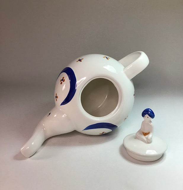 Ceramic neti pot with decorative design on a plain background