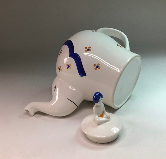 Ceramic elephant mug with a smaller elephant figure on a gray background