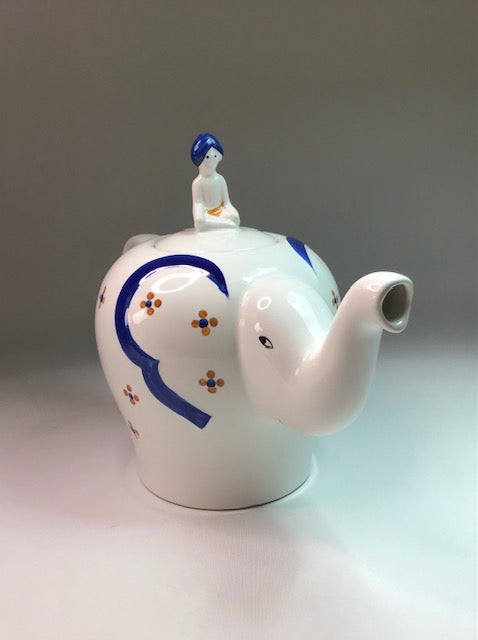 Ceramic teapot with decorative elements on a plain background