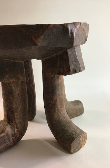 Wooden stool with a rustic design on a white background