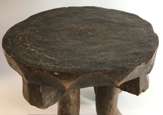 Wooden stool with a dark brown finish on a white background