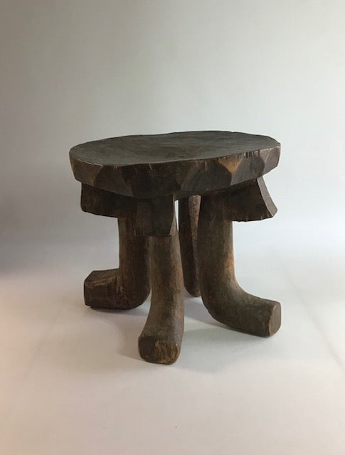 Wooden stool with a natural finish on a white background