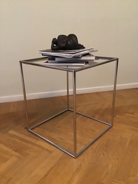 Glass display case with metal frame on a wooden floor