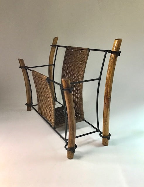 Wicker magazine rack with metal frame on a neutral background