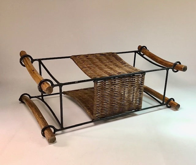 Wicker basket with metal frame and wooden handles on a white background