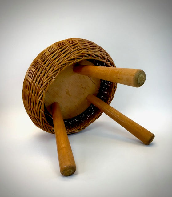 Wooden reel with wicker basket and wooden handles on a white background