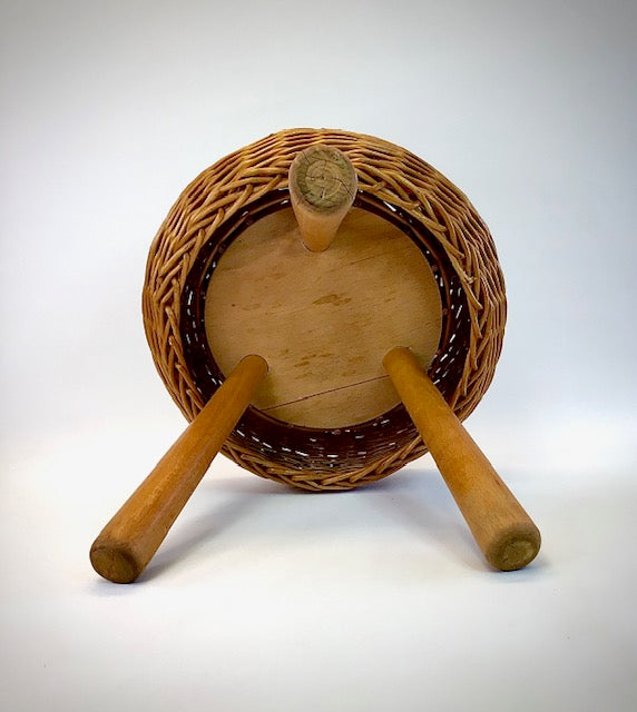 Wooden drum with two sticks on a white background