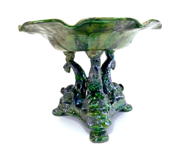 Decorative glass bowl with a base resembling trees and foliage on a white background