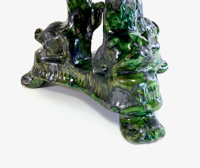 Decorative green stone sculpture of a bear and cub on a white background