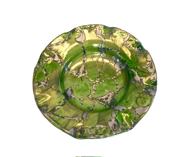 Green ceramic plate with marbled design on a white background