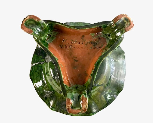 Decorative ceramic item with green and orange colors on a white background