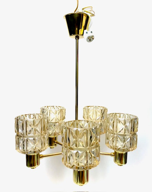 Vintage chandelier with crystal-like glass shades on a white background