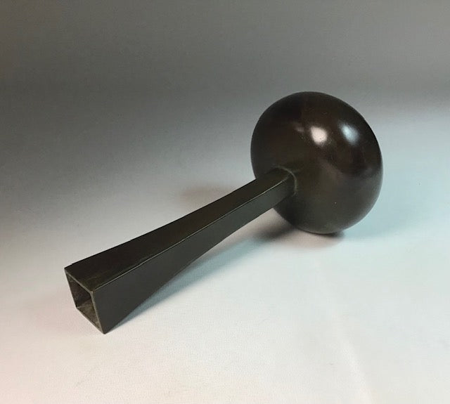 Black ladle on a gray background