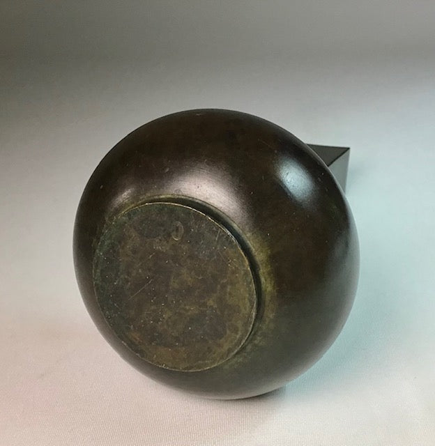 Bronze object on a neutral background