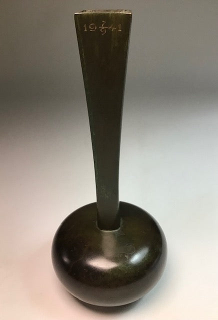 Bronze vase with a cylindrical base and flared top on a gradient background