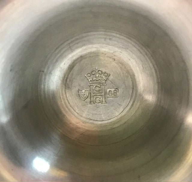 Close-up of a metallic object with a logo and text on its surface