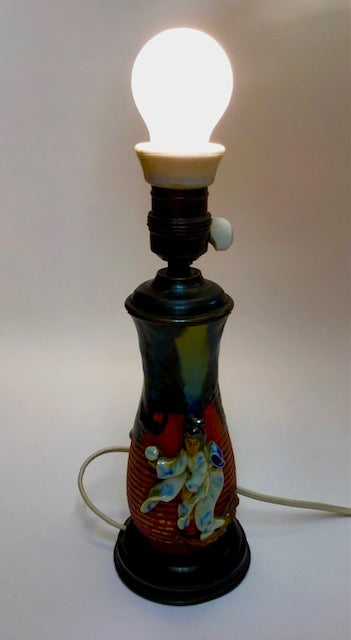 Decorative lamp with a light bulb on a plain background