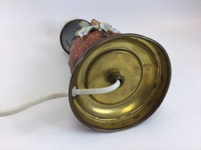Vintage-style lamp with brass base and ceramic shade on a white background