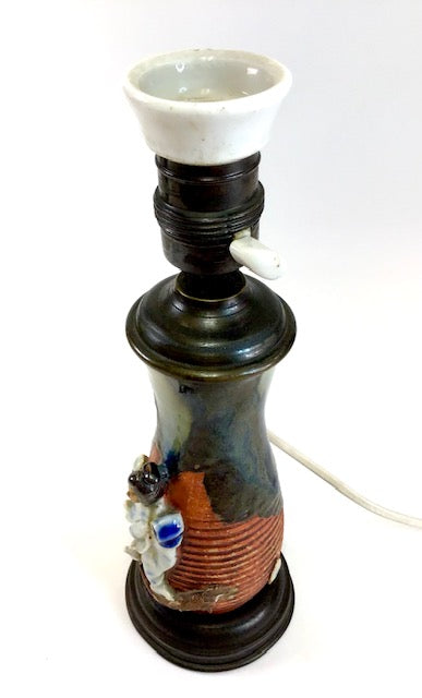 Decorative ceramic lamp with a white base on a white background