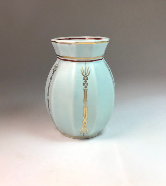 Decorative vase with gold accents on a gradient background
