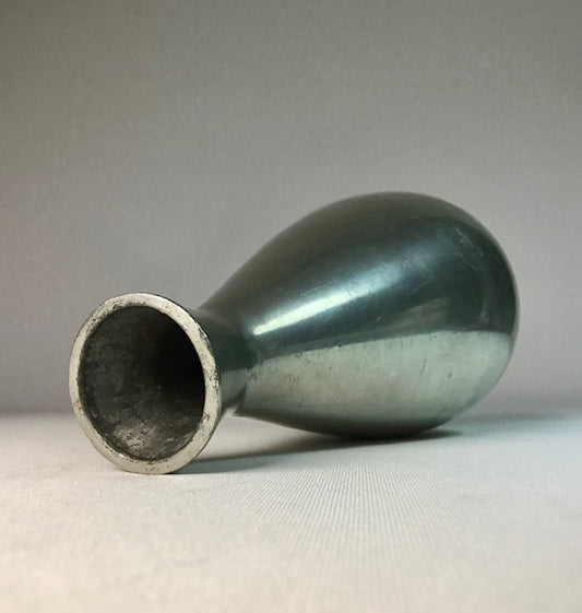 Green ceramic vase on a gray background