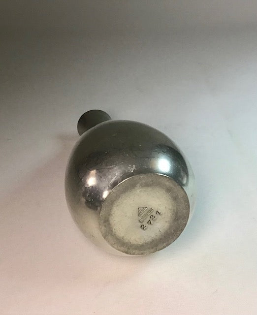 Silver bottle with a visible hallmark on a light gray background