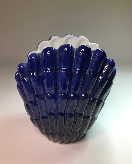 Ceramic vase with blue and white design on a neutral background