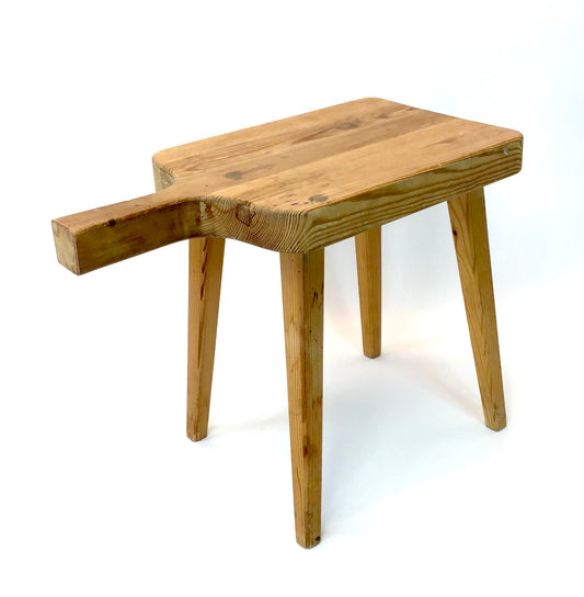 Wooden stool with a handle on a white background