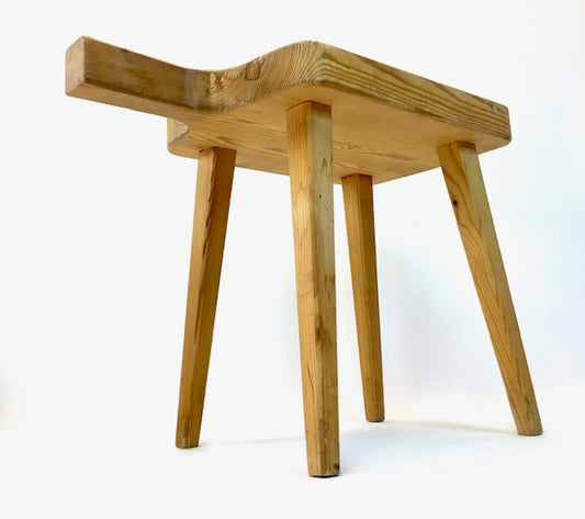 Wooden stool with a curved seat on a white background