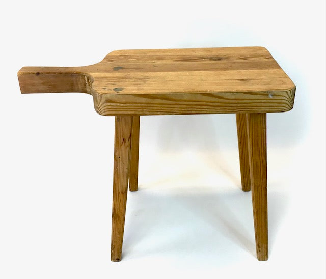 Wooden stool with a handle on a white background