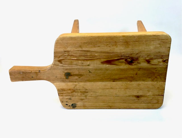 Wooden cutting board with handles on a white background