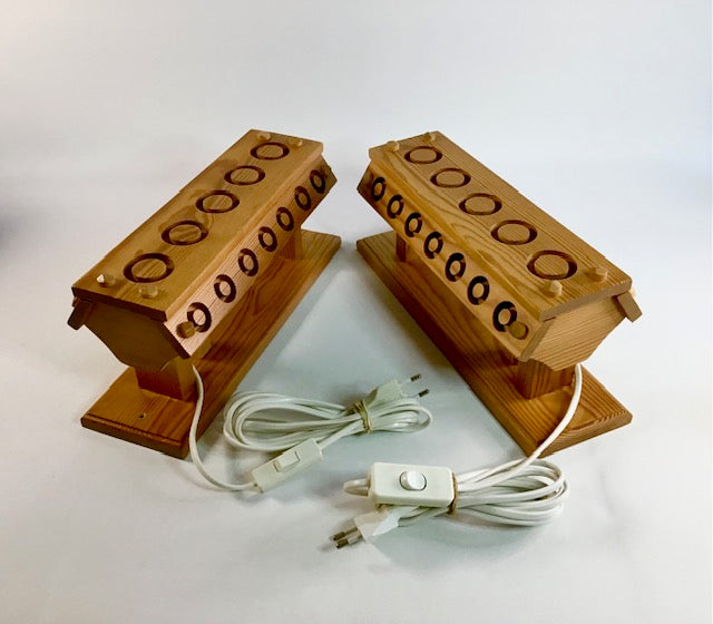 Wooden foot massager with electrical cord on a white background
