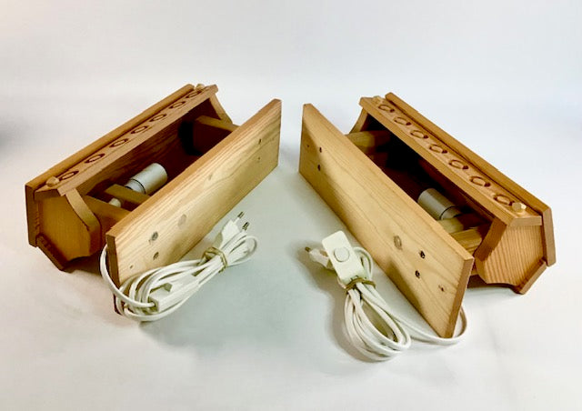 Two wooden electronic devices with cables on a white background