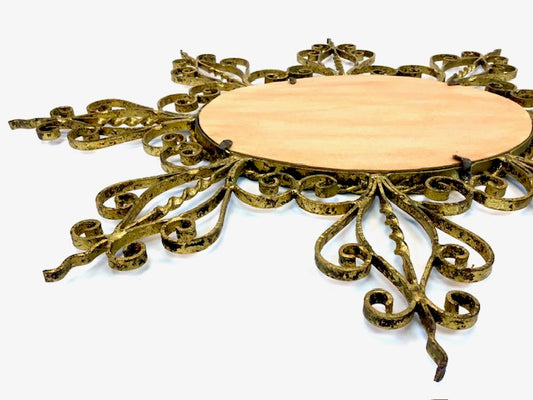 Decorative round table with intricate gold metalwork on a white background