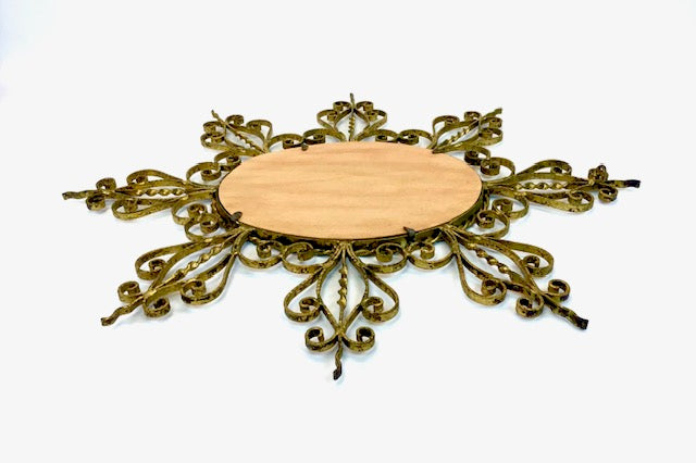 Decorative metal frame with a wooden center on a white background