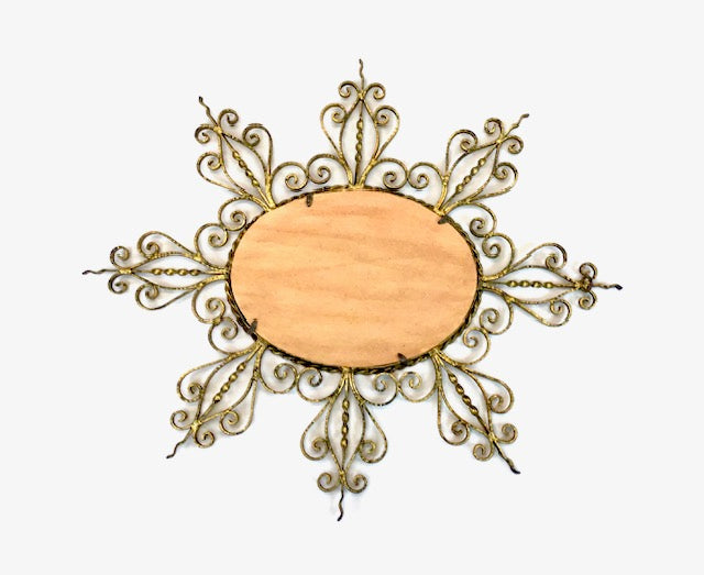Decorative wall mirror with intricate gold frame on a white background