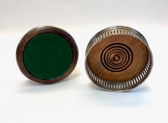 Two wooden objects with circular designs on a white background