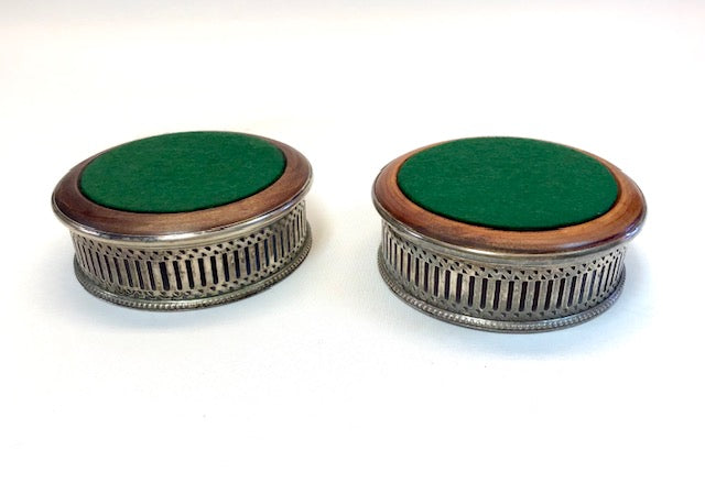 Two decorative boxes with green fabric tops and metal bases on a white background