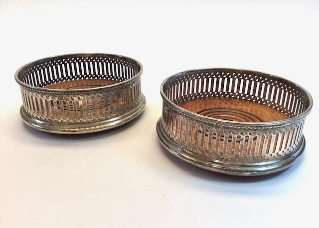 Two metallic bread baskets on a white background